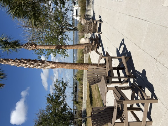 Adirondack chairs facing the Amelia River and marina